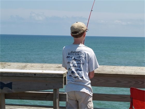 A young angler trying his luck at Jennette's Pier. The warm summer days will return but they can't come soon enough! 