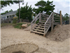 Wooden Stairs Leading to Beach With House in Background