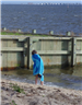 Child Wrapped in Towel Looking Out at the Water