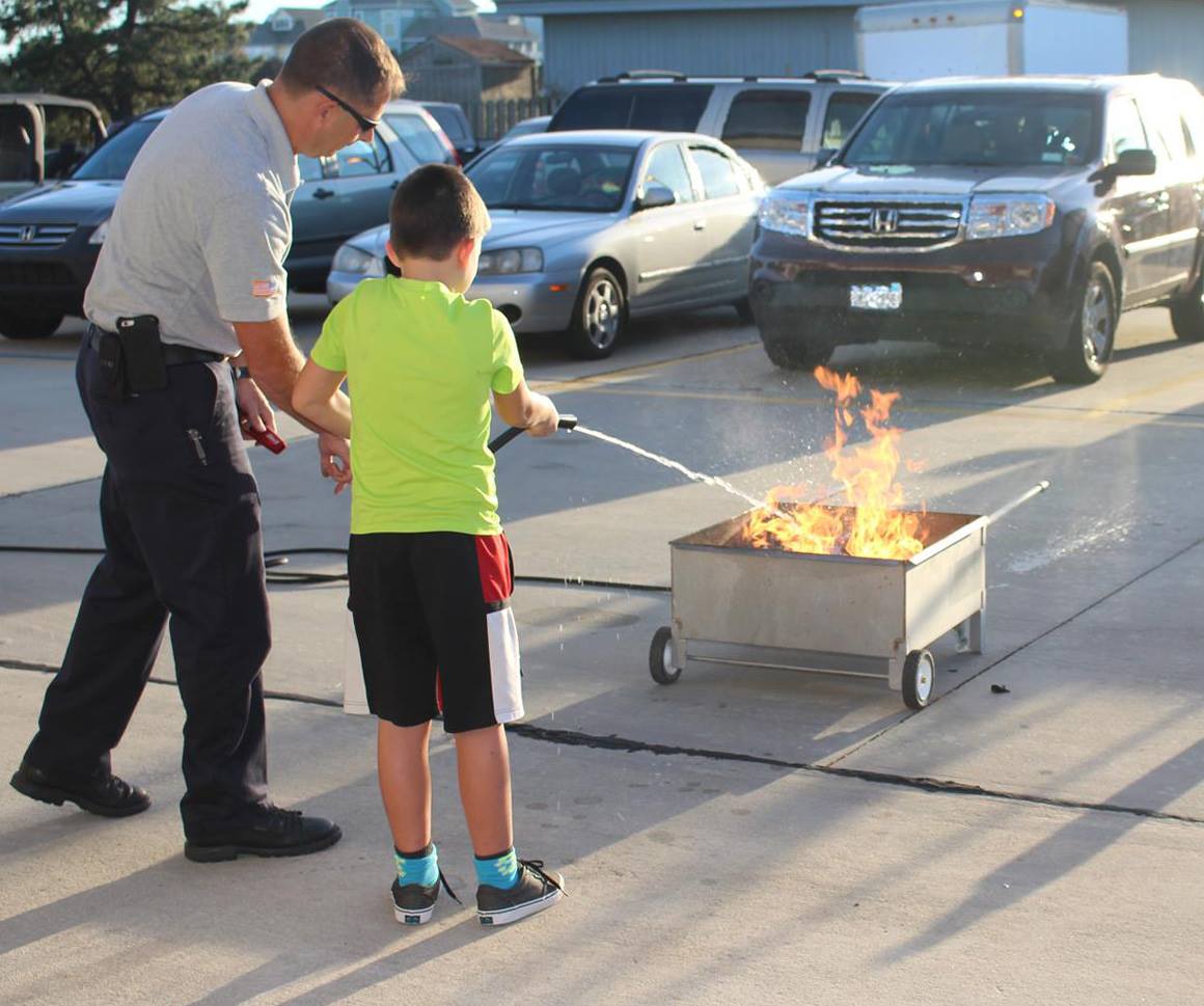 Man Teaching Fire Prevention to a Young Boy