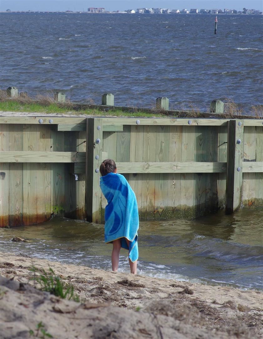 Child Wrapped in Towel Looking Out at the Water