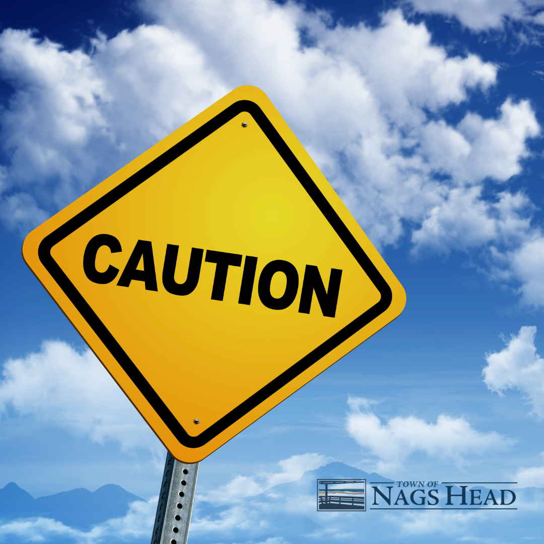 Caution sign on a Blue Sky with Clouds